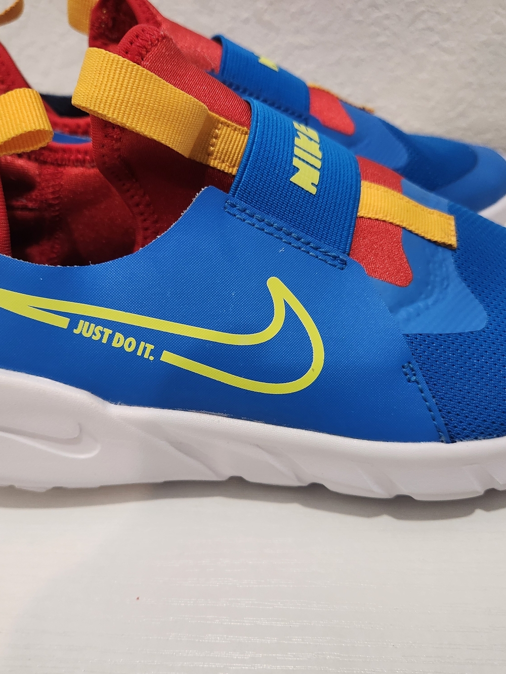 Nike Kids Blue Slip-On Sneakers with Red & Yellow Accents